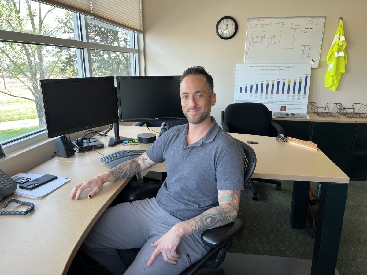 Nathan Travis sits at a desk