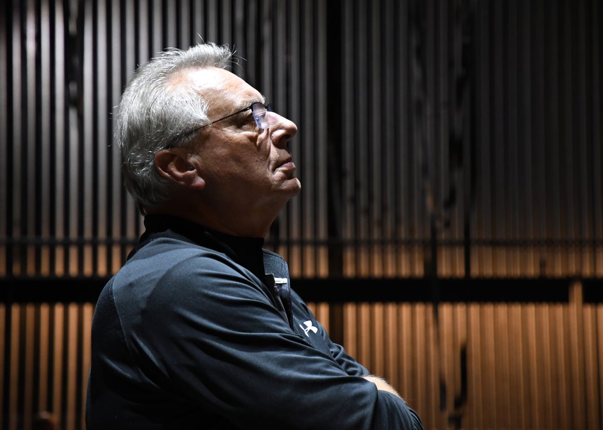 A man intently watches something out of frame.