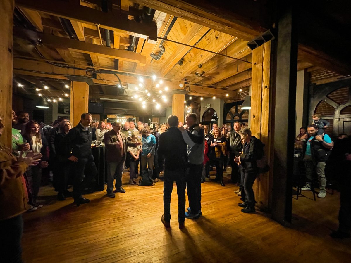 John Hickenlooper and Michael Bennet stand in front of a crowd ahead of Election Day.