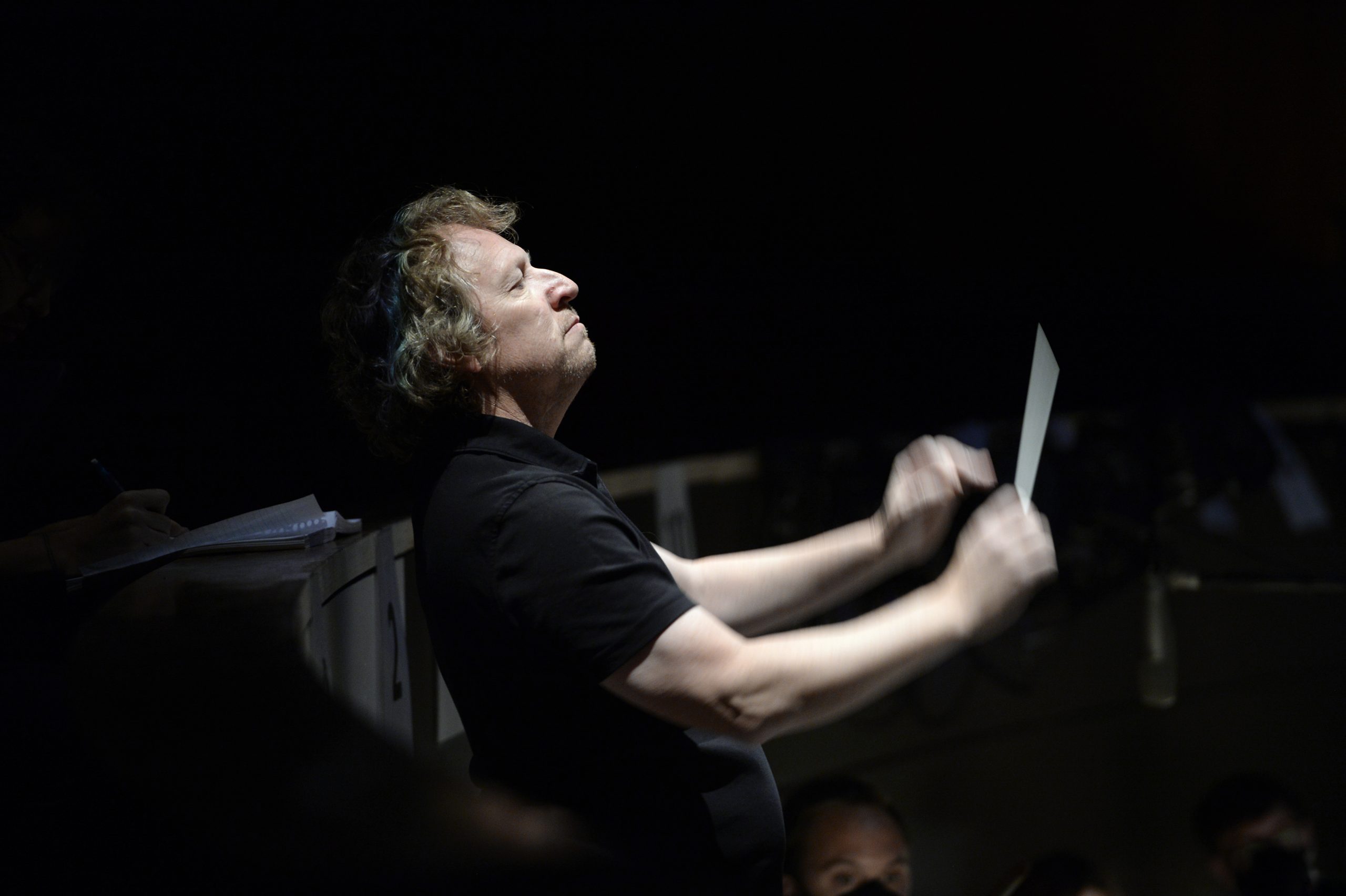A man conducts the opera.